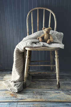 Little teddy bear on old country chair