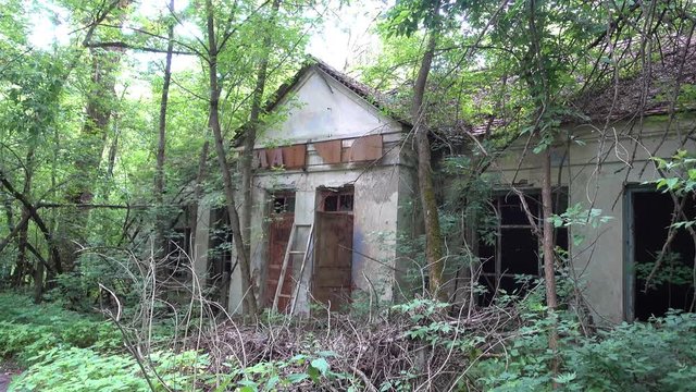 Chernobyl, Ukraine - 17th of June 2017: Visit to Zalesye village in Chernobyl zone - 4K Front view on the cultural house in Chernobyl zone