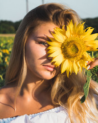 close-up portrait of a  girl with  a sunflower