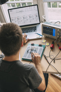Engineer Testing Electronic Equipment at Home