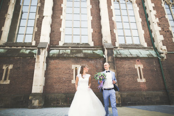 Obraz premium Gorgeous wedding couple walking in the old city of Lviv