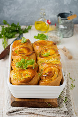 Buns with feta cheese and basil of yeast dough on a light wooden background. Selective focus. Rustic style.
