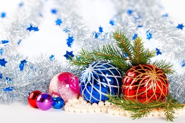 Christmas decorations and fir branches on white background with defocused tinsel