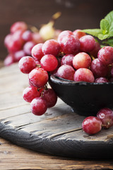 Sweet red grape on the wooden table