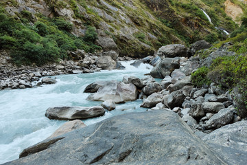 Naklejka na ściany i meble Rapids and waterfall of the mountain river