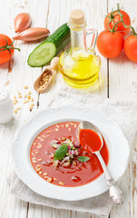 Gazpacho. Gourmet tomato soup with fresh vegetables - cucumber, onion, Basil and pine nuts. Vegetarian cuisine. Selective focus