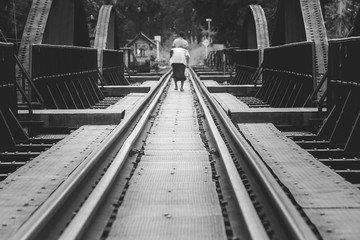 Abstract black and white image of The Bridge of River Kwae is historic buildings and landmark of Kancjanaburi Province, Thailand. (Selective focus)