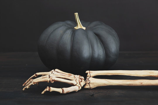 Black pumpkin with arm and hand