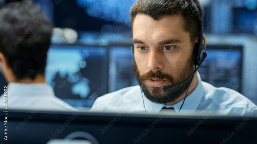 Poster customer service representative answer client's questions in a headset. he works for a big technolog