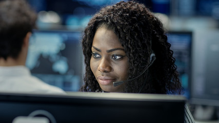 Female Customer Service Representative Answer Client's Questions in a Headset. He Works for a Big...