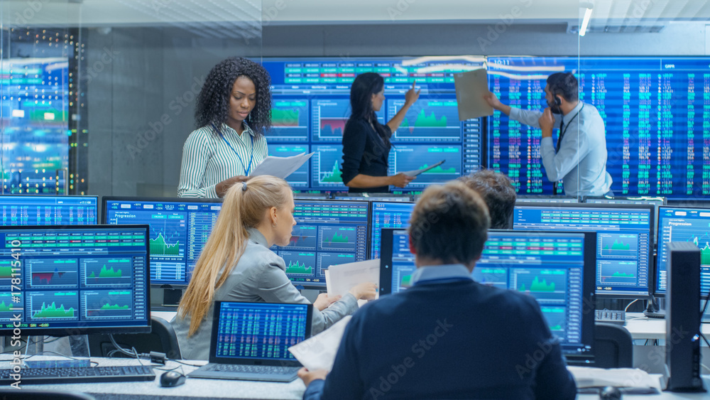Poster multi-ethnic team of traders is busy working at the stock exchange office. dealers and brokers buy a