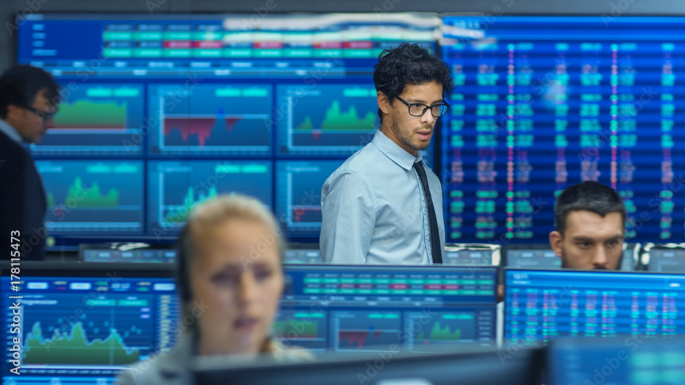 Poster Stock Trader Inspects Others Work and Chat with Other. Busy Office with Multi-Ethnic Team of Brokers, Dealers. Displays Show Numbers and Infographics.
