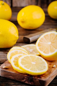 Fresh ripe lemon slices on wooden background