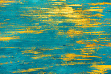 gold paint on a blue background
