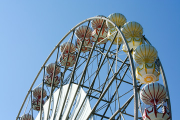 Old Vintage Ferris wheel over blue sky