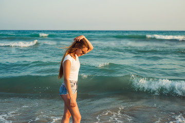 Girl With Long Hair on the background of the sea sunset
