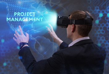 Business, Technology, Internet and network concept. Young businessman working in virtual reality glasses sees the inscription: Project management