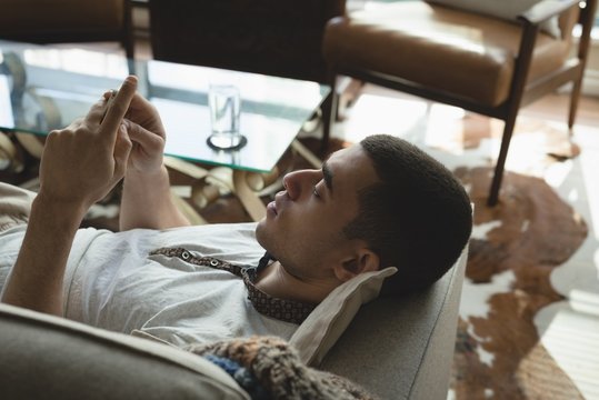 Man using mobile phone in the living room