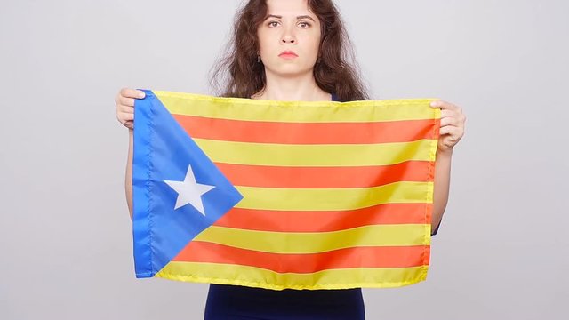 Serious catalan woman with estelada flag. Referendum For The Separation Of Catalonia From Spain