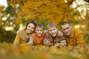 Fototapeta premium smiling family in autumn forest 