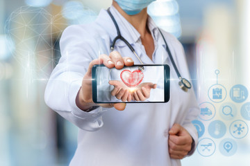 Heart in hands on a mobile phone.