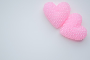 Two pink hearts on a white background