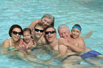 Family relaxing in  pool