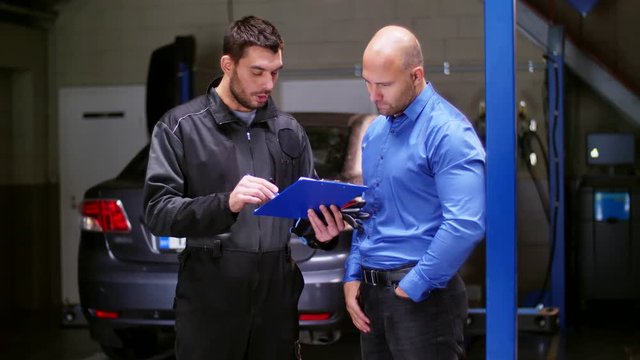 mechanic and customer shaking hands at car service