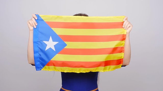 Serious catalan woman with estelada flag. Referendum For The Separation Of Catalonia From Spain