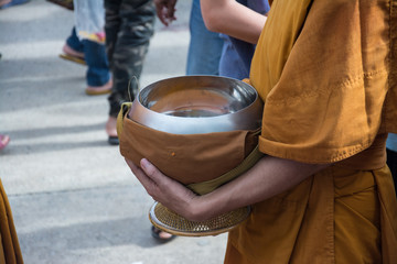  Buddhist monks are given food offering from people for End of Buddhist Lent Day