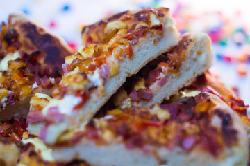Homemade pizza on a white wooden background.
