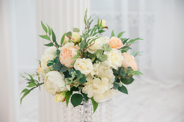 Artificial flowers. Vase with a flower arrangement in an expensive interior.