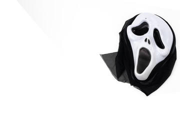 Halloween ghost mask with a knife on white background