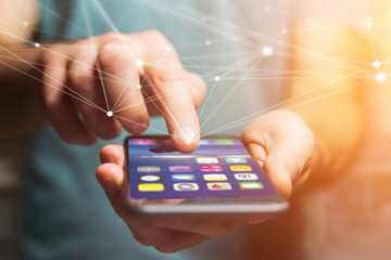 Hand holding smartphone with operating system screen and network connection