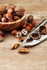 Large diversity of healthy nuts in wooden bowl.