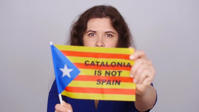 Serious catalan woman with estelada flag. Referendum For The Separation Of Catalonia From Spain