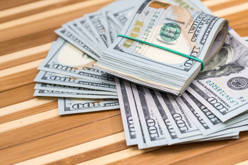 american dollar on wooden desk. close up