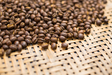 Depth of field shot, soft focus, Medium dark Roasted peaberry coffee beans background with copy space.