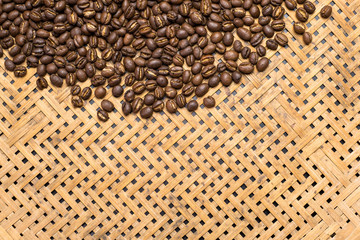 Flay lay style, Medium dark Roasted peaberry coffee beans on bamboo handcraft background with copy space.
