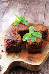 Cake chocolate brownies on wooden background with mint