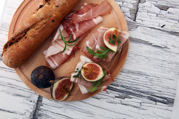 Sandwich with figs and prosciutto. Antipasti gourmet bruschetta snack.