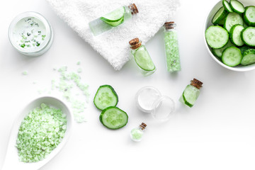 Fototapeta na wymiar Fresh organic cosmetics with cucumber. Cream and lotion on white background top view