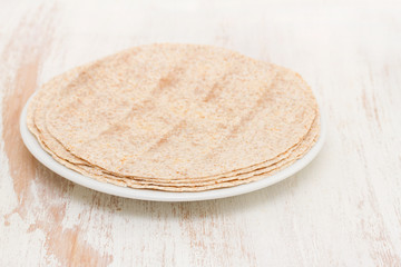 pita on white plate on wooden background