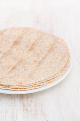 pita on white plate on wooden background