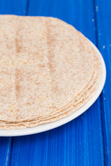 pita on white plate on wooden background