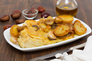 fried cod fish with chestnuts and potato  on white dish