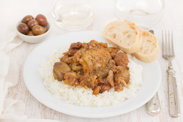 chicken with chestnuts and boiled rice on dish