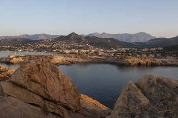 Fototapeta na wymiar Corsica, 30/08/2017: lo skyline di Isola Rossa, famosa città dell'Alta Corsica, con vista al tramonto del porto e della città vecchia