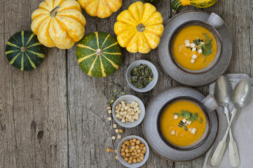 Obraz na płótnie Canvas Creamy pumpkin soup topped with pumpkin seeds close-up