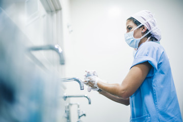 Doctors washing hands before operation